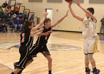 Crum's #23 Jesse Muncy hitting a three pointer while getting fouled vs Fort Gay. Muncy scorched the nets for 33 points on the night.