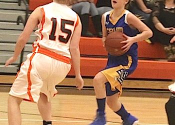 Autumn Block of Crum going to the basket as Bailey Rose of Fort Gay gets in defensive position.