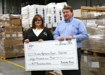 Kentucky Power President Matt Satterwhite presents a $50,000 AEP Foundation grant to Teresa Gullett, manager of Elderly Services for Christian Appalachian Project, at the agency&rsquo;s warehouse in Paintsville. The grant will fund weatherization and home repair services.