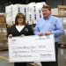 Kentucky Power President Matt Satterwhite presents a $50,000 AEP Foundation grant to Teresa Gullett, manager of Elderly Services for Christian Appalachian Project, at the agency’s warehouse in Paintsville. The grant will fund weatherization and home repair services.