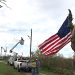 Kentucky Power crews fly an American flag found in debris from a tree on their last day of restoring power for AEP Texas in Rockport, Texas. They say they wanted to leave a symbol of hope.