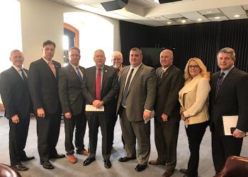 Legislators Meet With PSC On Power Rates On Thursday, Democratic Floor Leader Senator Ray S. Jones II, D-Pikeville, Senator Johnny Ray Turner, D-Prestonsburg, and Senator Robin Webb, D-Grayson, along with Senator Brandon Smith, R-Hazard, and other eastern Kentucky legislators attended a briefing with members of the Public Service Commission. After the discussion, the commission announced the decision that had been reached in the Kentucky Power Rate case. The power company had been seeking a 16 percent increase, but the ruling by the PSC actually resulted in a reduction of rates by 4.04 percent. Shown from left to right are Rep. Scott Wells, R-West Liberty; Sen. Smith; Rep. Larry Brown, R-Prestonsburg; Rep. John Blanton, R- Salyersville; Rep. Danny Bentley, R-Russell; Rep. Chris Fugate, R-Chavies; Senator Turner; Senator Robin Webb, and Senator Jones.