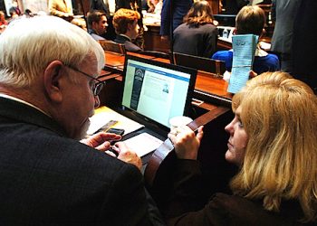 FRANKFORT, Jan. 11-- Rep. Danny Bentley, R-Russell (left), speaks with Rep. Jill York, R-Grayson, on the floor of the House.
