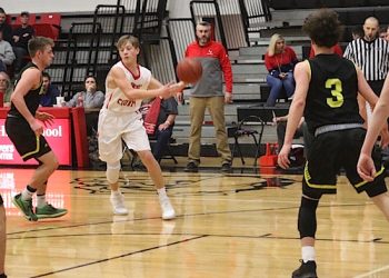 Bulldog Freshman Baden Gillispie looking to pass as coach Travis York looks on.