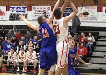 #23 Westin Hardin of LCHS going up strong as #11 Austin Salmons of THS defends.