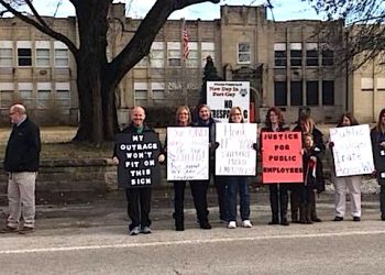 Ft. Gay teachers held up signs in front of the old Ft. Gay High School asking the public's support for decent pay and health insurance.