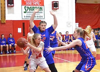 Kayla and Sarah Jude trapping the Tygarts Valley player under the basket.