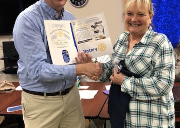 New Rotary member Kathy Kize Wells is welcomed by President Chris Jobe.
