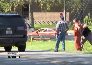 Johnson Co. Sheriff's deputy Terry Tussey arrests escapee justin Harless (in orange suit) on the street behind W.R. Castle elementary school. PHOTO/WYMT