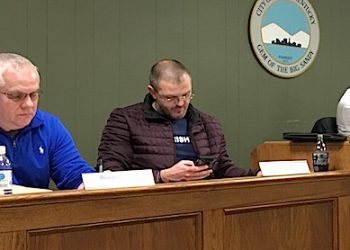 Louisa City Council members Ron Cordle (left) and Matt Brown were listening to mayor Harold Slone's presentation at last night's council meeting.