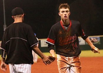 LC's Tyler Maynard gets a much deserved hand shake from Asst. coach Jackie Holt after his 2 Run single in the sixth inning.