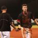 LC's Tyler Maynard gets a much deserved hand shake from Asst. coach Jackie Holt after his 2 Run single in the sixth inning.