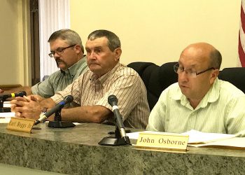 Judge/Executive John Osborne sat next to a potential rival for his $89,000 job, Republican Earl Boggs at Tuesday's Lawrence Co. Fiscal Court meeting while Magistrate Rick Blackburn, also a Republican up for re-election in District 4, listens carefully..