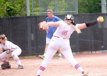 LC's Ciana Bowen strides toward the plate for one of her 11 k’s vs Paintsville as former LCHS baseball coach Randy Keeton, now coaching Girls Softball at Paintsville, looks on.