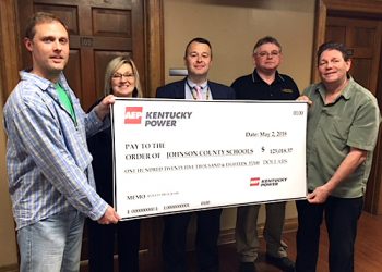 From left, Kentucky Power’s Shawn Sumner and Linda Bevins present about $125,000 to Johnson County Schools Superintendent Thom Cochran, Director of Operations Tim Adams and Energy Manager Terry Salyer. The county earned the rebates for energy efficiency upgrades made at seven schools in 2017.