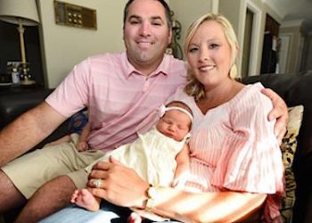 Larry and Stacey Freels with their new daughter, Magdalene Marie, four days old, on Monday in their home. Photo by Alan Warren
