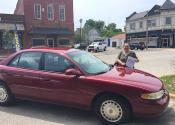 Donna Fluty with her new car. Lazer photo by Gina Woods