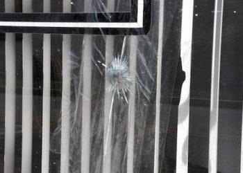 Tape covers the damage from what Paintsville Police said may have been a .22 caliber round fired into the window of attorney Robert Miller's office. (Paintsville Herald photo by Aaron K. Nelson)