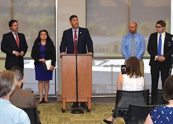 Democratic Rep. Chris Harris, center, addresses the audience at an event he hosted with Rep. Angie Hatton at the Pikeville library Tuesday. The event focused on the estimated 500,000 Kentuckians who were recently cut from their dental and vision benefits. Pictured with Harris, from left to right, are: former State Auditor Adam Edelen, Rep. Hatton and two candidates for the House of Representatives, Ryan Mosley and Craig Lindon. (News-Express photo by Josh Little)