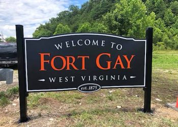 The sign is painted in the old Ft. Gay High School colors of black and orange.